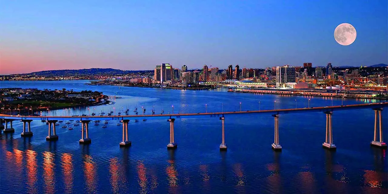 Luxury yacht anchored in San Diego Bay with the city skyline in the background