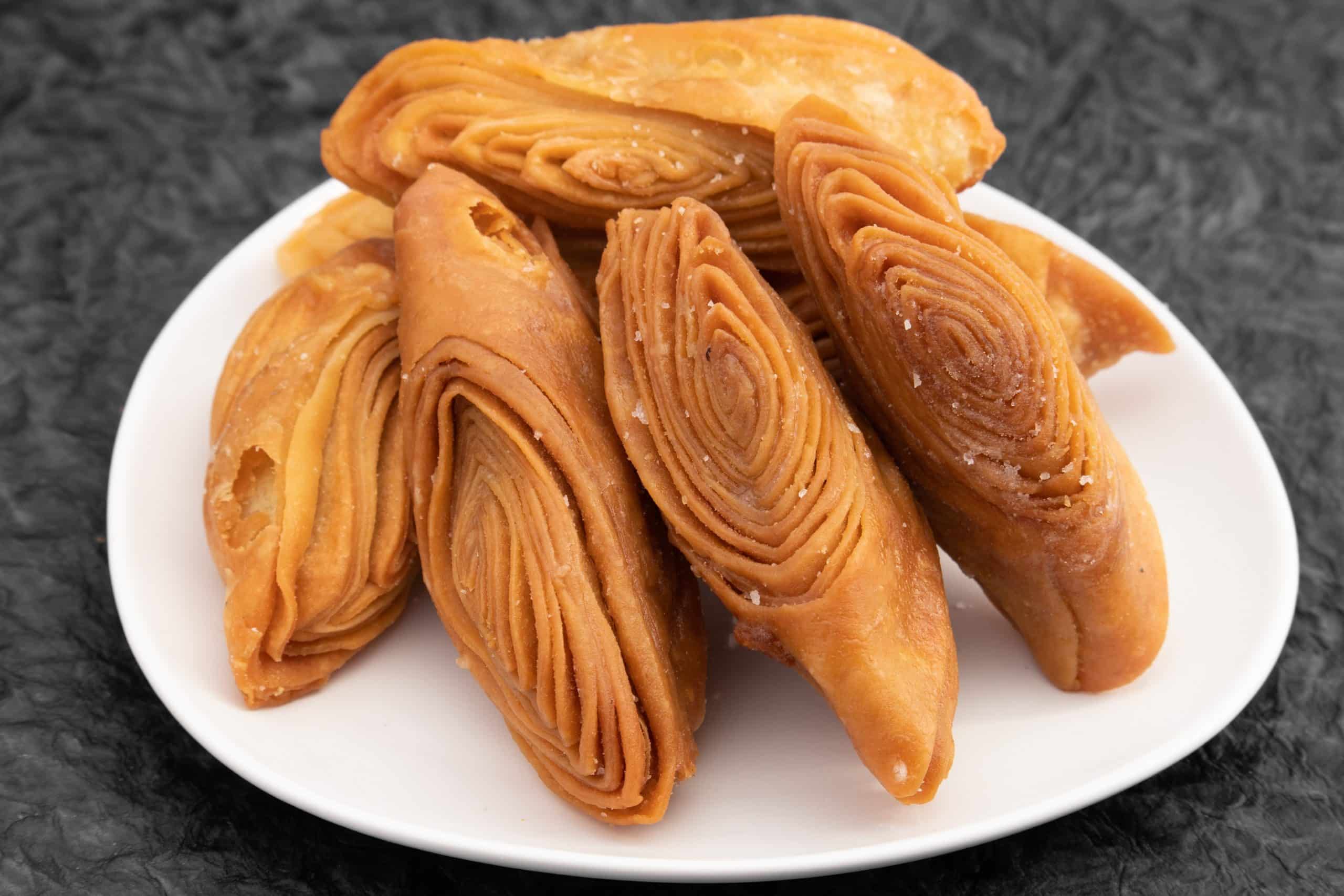 Freshly fried Khaja cooling in a basket 